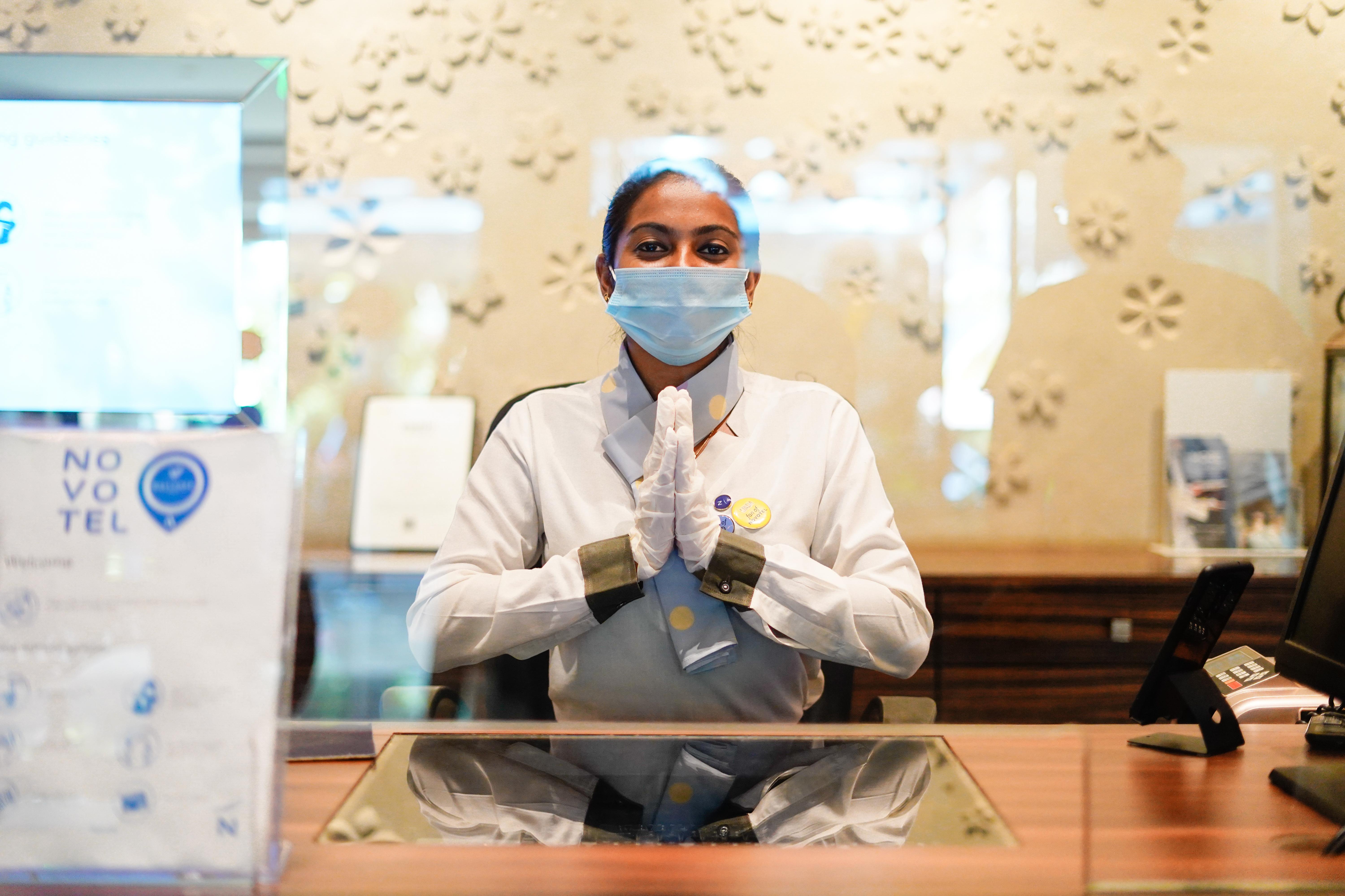 Novotel Goa Resort & Spa Candolim Esterno foto A hotel employee wearing a face mask